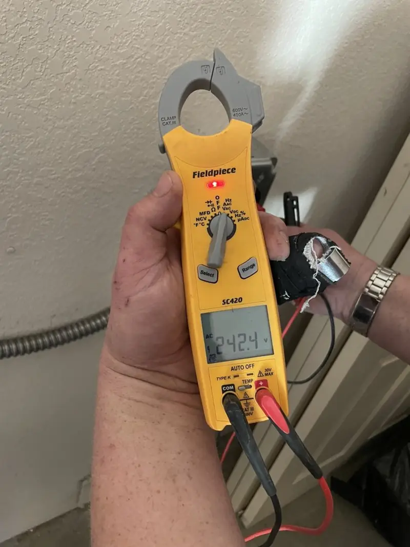 Voltage testing with clamp meter during Recessed Lighting Installation in Tempe